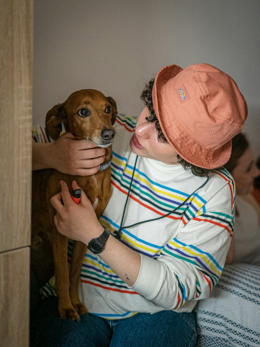 a woman is holding a dog in her arms
